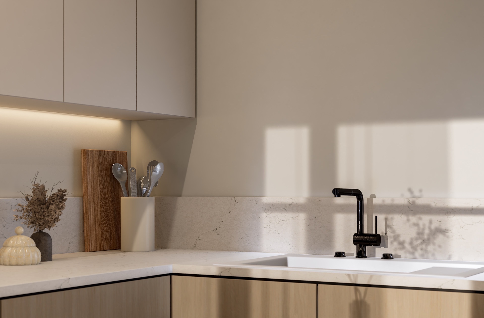 Detail of the kitchen counter with marble backsplash, black faucet and warm under-cabinet lighting