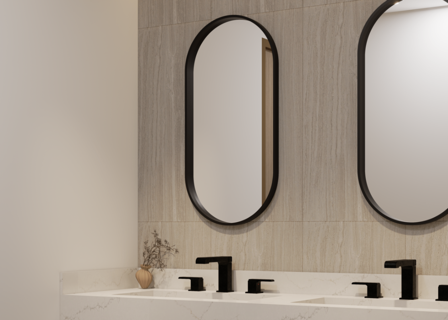 Detail of the office restroom's marble vanity, matte black fixtures and arched mirrors