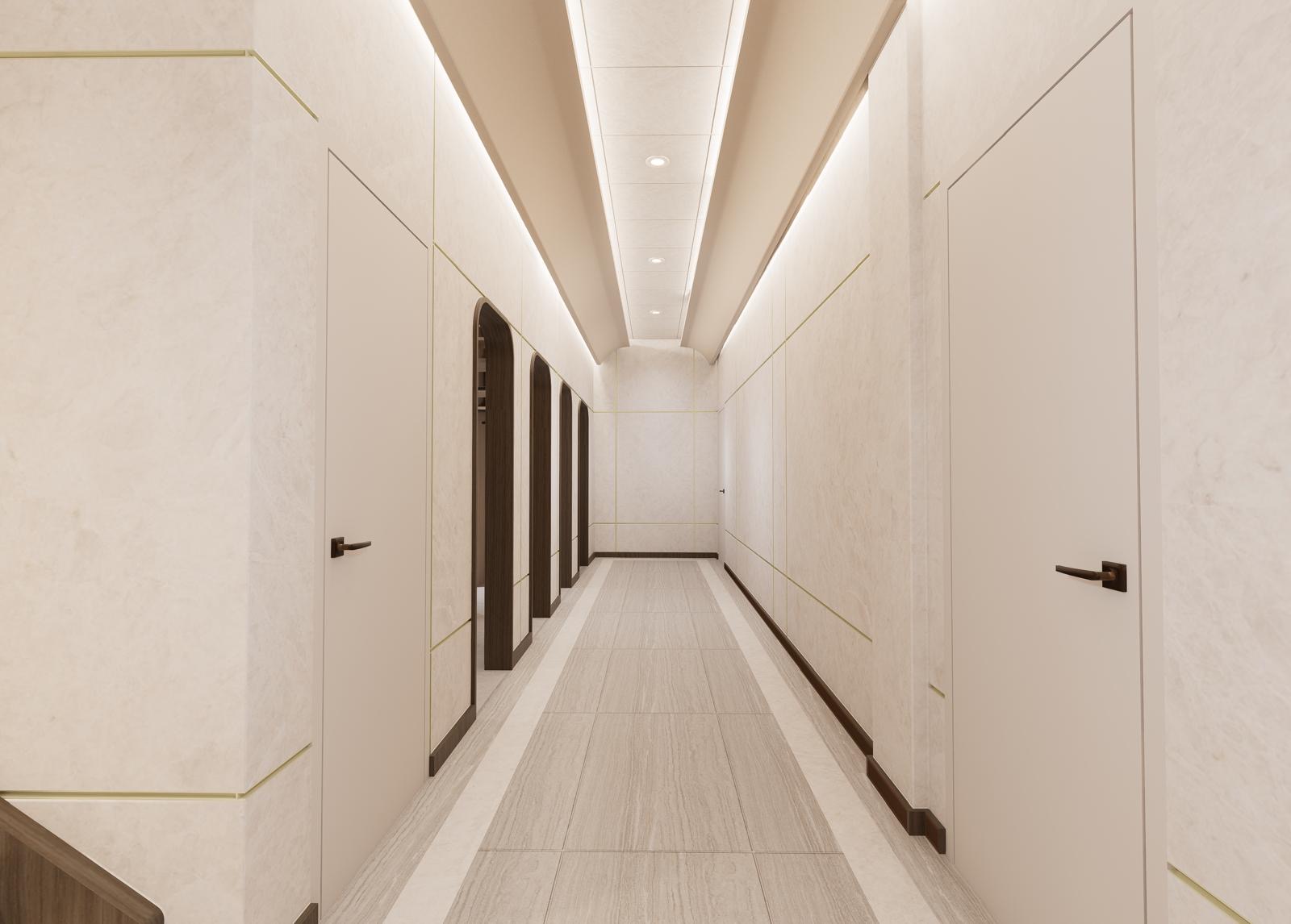 Symmetrical corridor view with stone panel walls, flush doors and a continuous illuminated ceiling slot