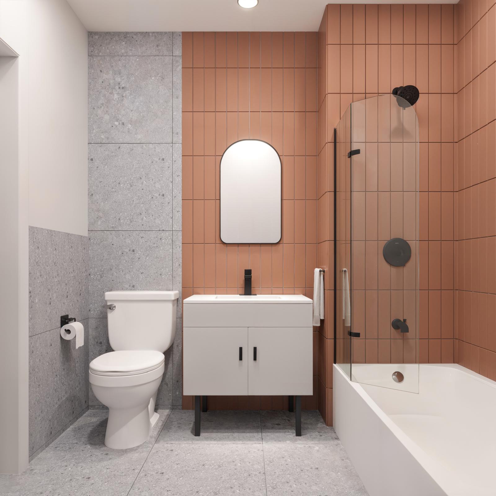 Unit bathroom with vertical terracotta tile, grey terrazzo, arched mirror and black fittings