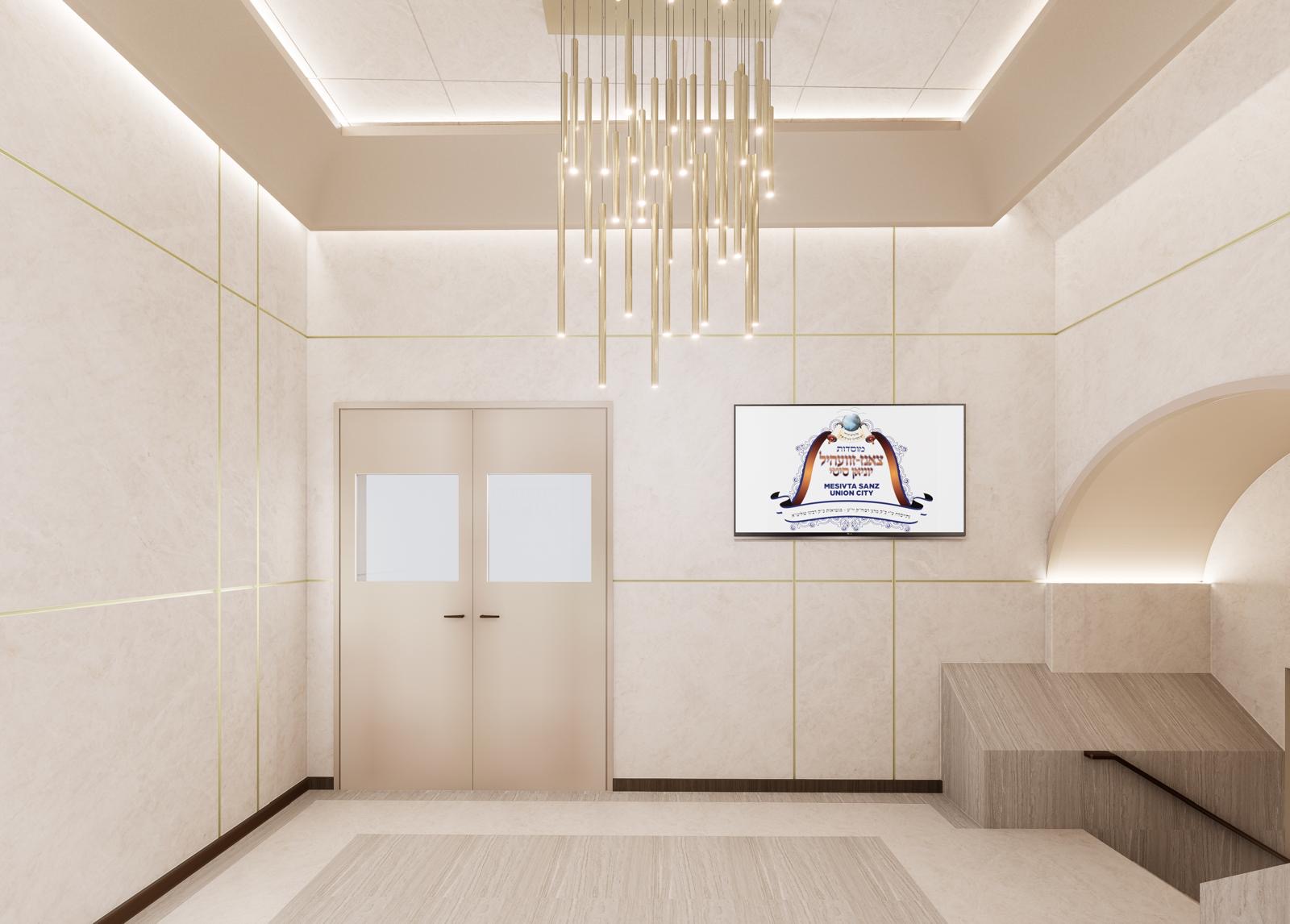 Stone-clad shul entry hall with recessed cove lighting and a vertical rod chandelier
