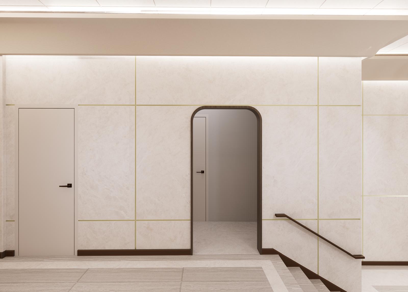 Arched timber portal set into a stone panel wall beside a flush door and stair handrail