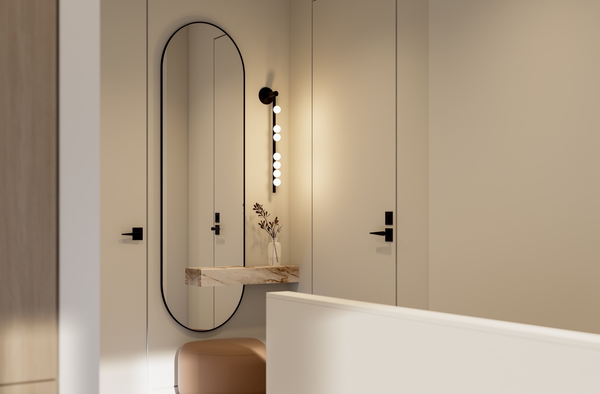 Apartment entry with oval black-framed mirror, floating marble ledge, sconce and leather ottoman