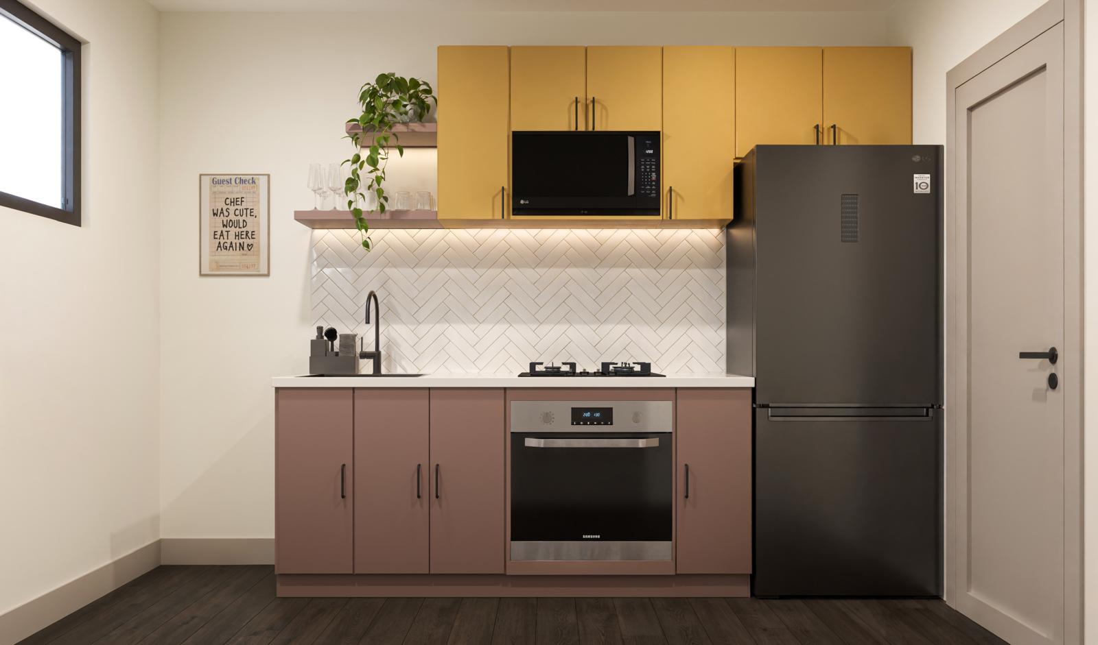 Unit kitchenette with ochre upper cabinets, blush base cabinets and herringbone tile backsplash
